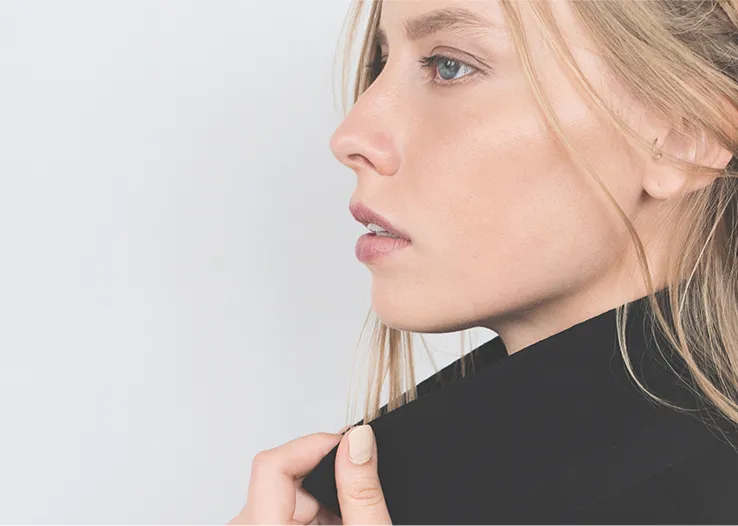 Side profile of a blonde model in a black top, fashion and beauty portrait