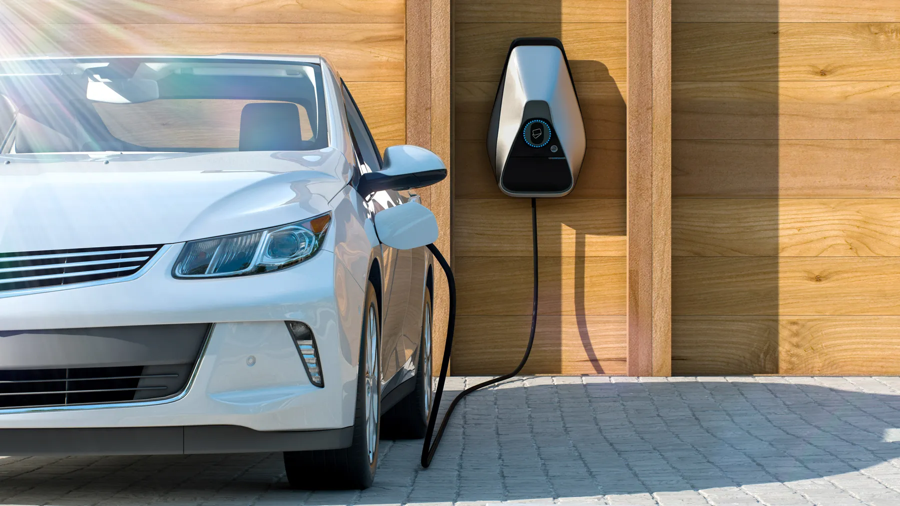 White electric car charging from a wall-mounted home charger